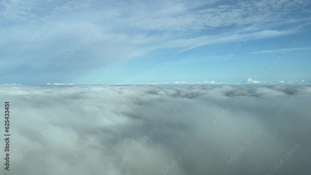 Overflying a blanket of clouds during cruise level phase shot from an airplane cabin, flying at 12000m high. A pilot’s perspective Overflying a blanket of clouds during cruise level phase shot from an airplane cabin, flying at 12000m high. A pilot’s perspective