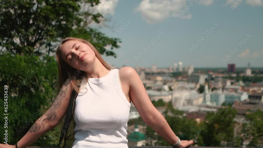 beautiful girl posing on the background of the city in sunny weather beautiful girl posing on the background of the city in sunny weather