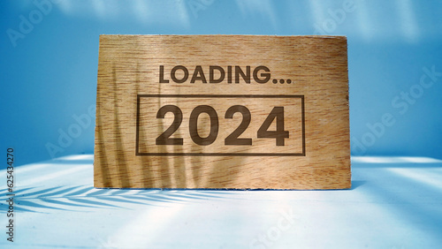 2024 New Year Loading. Loading bar with wooden blocks 2024 on blue background. Start the new year 2024 with a goal plan, goal concept, action plan, strategy, and new year business vision.