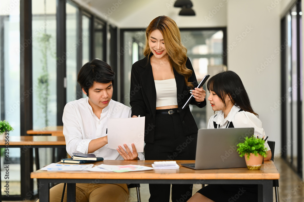 Millennial woman business team leader explaining project information to colleague Millennial woman business team leader explaining project information to colleague