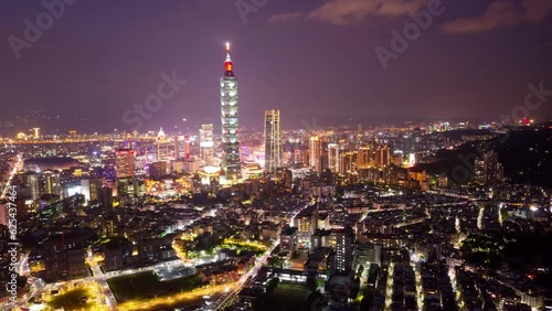 Wallpaper Mural Aerial hyperlapse of Downtown Taipei at night, the vibrant capital city of Taiwan, with 101 Tower standing out amid modern skyscrapers in XinYi Commercial District and city lights dazzling in the dark Torontodigital.ca