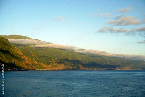Panoramic view of rocks above the ocean on Madeira island. Atlantic. Clouds and shadows under the clouds.
