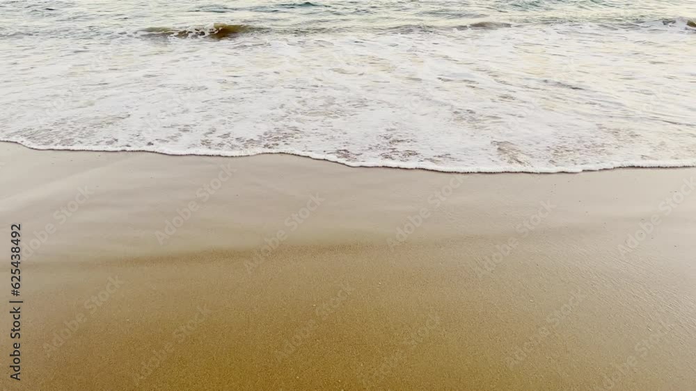 Ocean waves on the sandy beach. Ocean waves on the sandy beach.