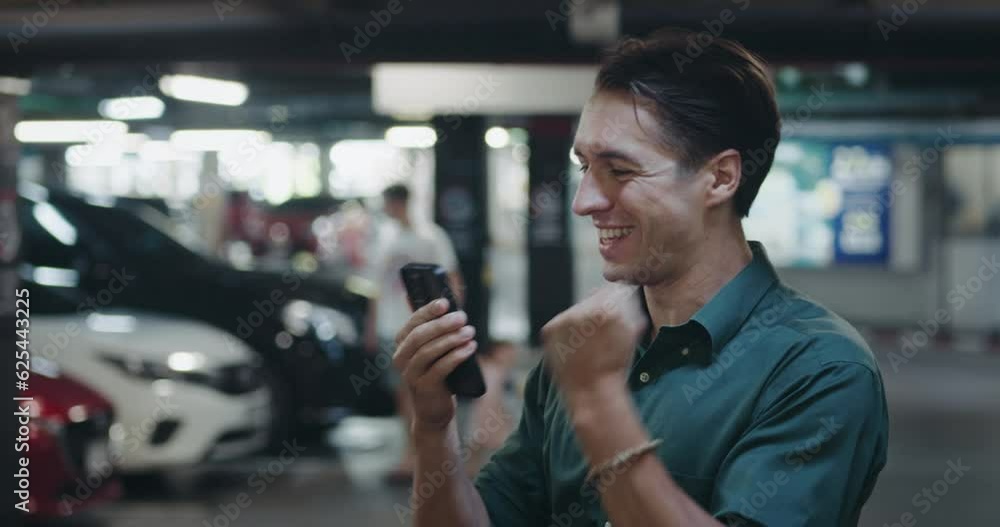 handsome young man with luck. male got new text messages in smartphone and say yes concept man with luck. guy standing in parking reading good news on his mobile phone man with luck handsome young man with luck. male got new text messages in smartphone and say yes concept man with luck. guy standing in parking reading good news on his mobile phone man with luck