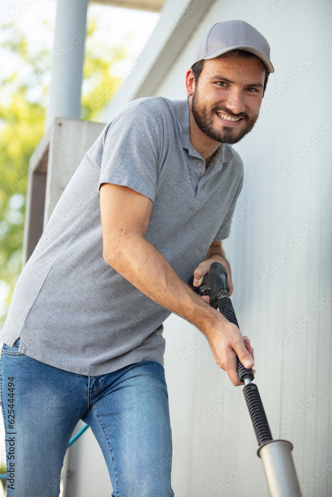 one adult man is hoovering smiling to the camera one adult man is hoovering smiling to the camera
