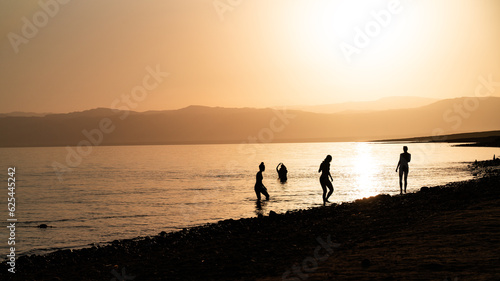 Fototapeta Naklejka Na Ścianę i Meble -  silhouettes against sunset at dead sea in jordan