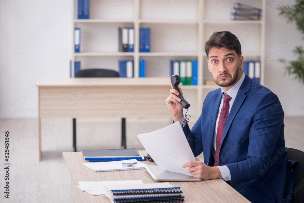 Young male employee working in the office Young male employee working in the office