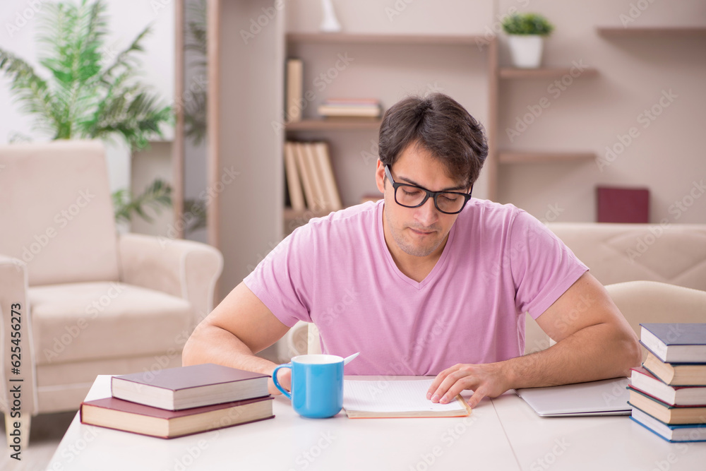 Young male student preparing for exams at home Young male student preparing for exams at home
