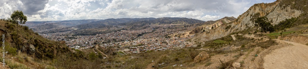 View from the scenic road to the landmark Muela del Diablo over the highest administrative capital, the city La Paz and El Alto in Bolivia - Panorama