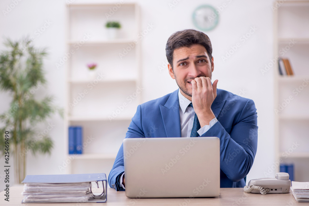 Young male employee working in the office Young male employee working in the office
