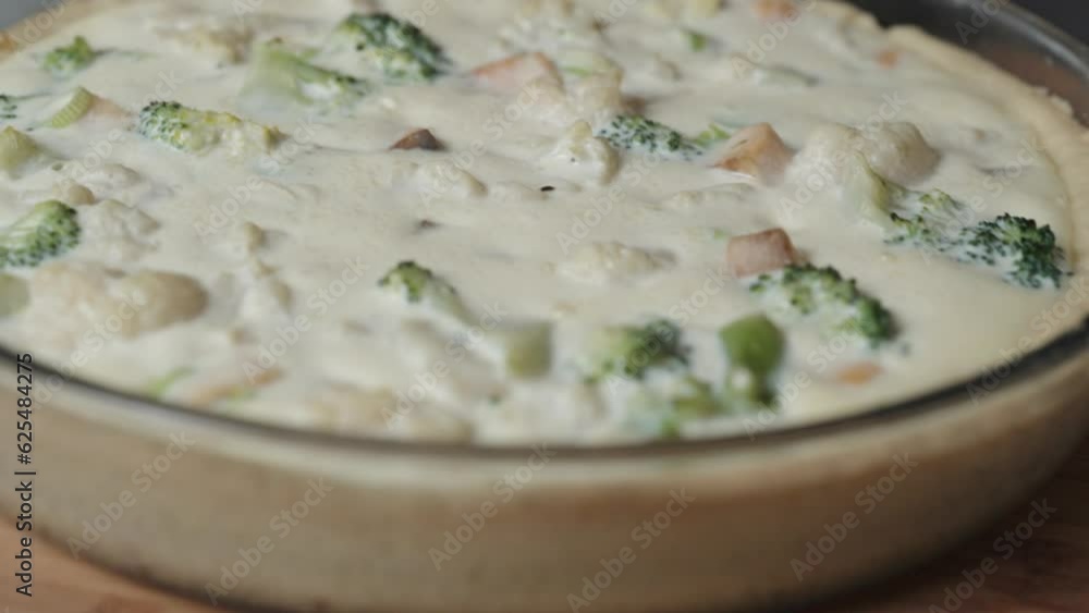 A vegetable pie with colorful cauliflower and salmon, topped with a creamy sauce. A vegetable pie with colorful cauliflower and salmon, topped with a creamy sauce.
