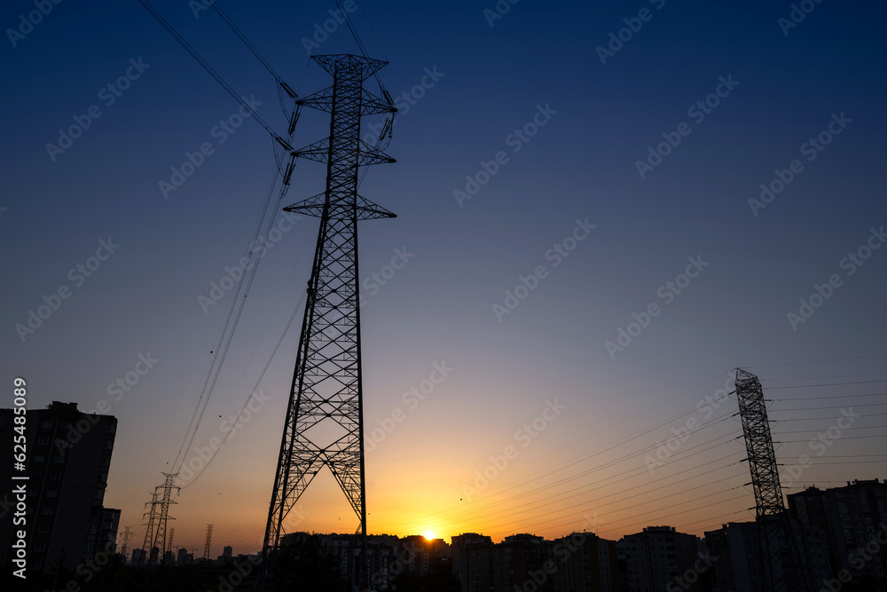Fototapeta premium Electricity transmission tower with sunset