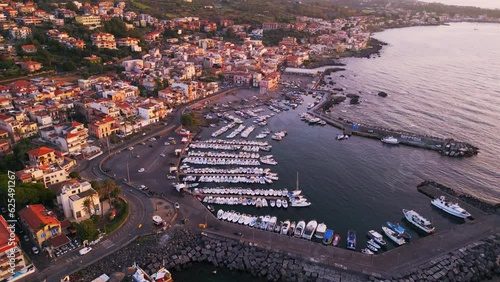 Aerial view of Aci Trezza, a seaside village in the countryside near Catania in Sicily.
Traditional harbor on the cliff overlooking the stacks of the mythologyIslands of Greek mythology of Polyphemus. photo