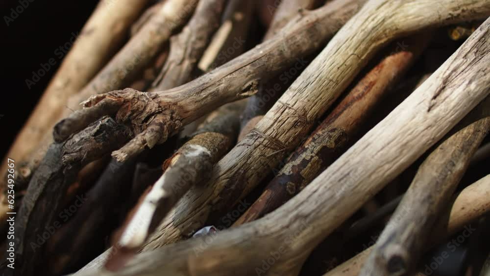 a bunch of brushwood with sun glare, dry branches for a fire close up 4K footage a bunch of brushwood with sun glare, dry branches for a fire close up 4K footage