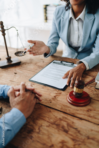 african american attorney, lawyers discussing contract or business agreement at law firm office, Business people making deal document legal, justice advice service concepts photo