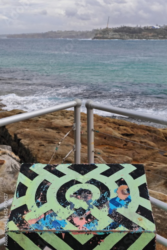 Green-black monolith at the stainless steel railing corner marking the Bondi Beach northeasternmost end. Sydney-Australia-727 photo