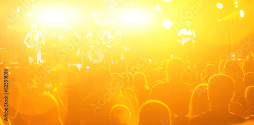 The stage lighting effect in the dark. Happy young people. Lifestyle concept. Crowd at concert and blurred stage lights