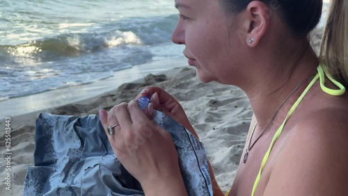happy smiling woman inflate inflatable ring to swim at the sea summer vacation