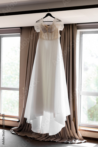 light and elegant bride's dress on a mannequin in a chic luxury interior