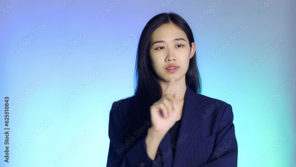 asian businesswoman pointing isolated over neon blue background in studio. Virtual Reality AR concept 4K video. asian businesswoman pointing isolated over neon blue background in studio. Virtual Reality AR concept 4K video.