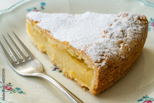 A piece of Custard cream cake with pine nuts. Traditional italian cake - torta della nonna or grandmother's cake. Tuscany pastry.