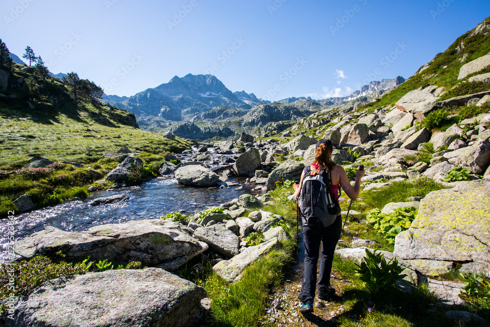 Young hiker girl summit to Ratera Peak in Aiguestortes and Sant Maurici National Park, Spain Young hiker girl summit to Ratera Peak in Aiguestortes and Sant Maurici National Park, Spain