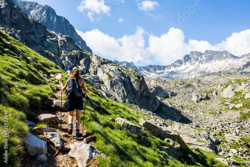 Young hiker girl summit to Ratera Peak in Aiguestortes and Sant Maurici National Park, Spain