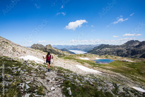 Young hiker girl summit to Ratera Peak in Aiguestortes and Sant Maurici National Park  Spain