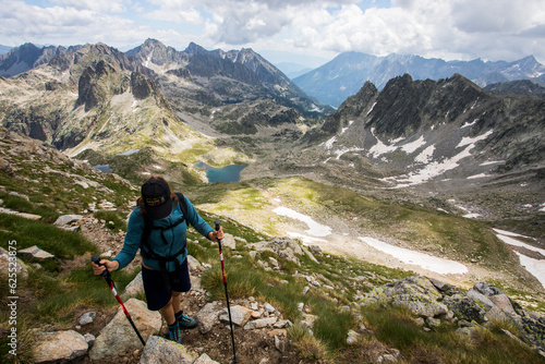 Young hiker girl summit to Ratera Peak in Aiguestortes and Sant Maurici National Park, Spain