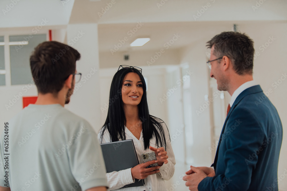 The director conducts a conversation with the secretary and a young programmer in a modern and spacious corridor of a large company, discussing various business topics and projects. The director conducts a conversation with the secretary and a young programmer in a modern and spacious corridor of a large company, discussing various business topics and projects.