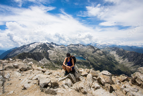 Young hiker girl summit to Montardo Peak in AIguestortes and Sant Maurici National Park, Spain