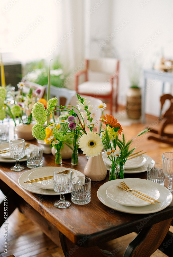 serving the table with fresh flowers and candles serving the table with fresh flowers and candles