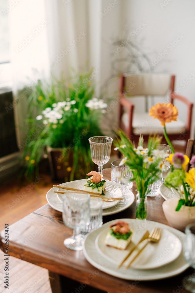 serving the table with fresh flowers and candles serving the table with fresh flowers and candles