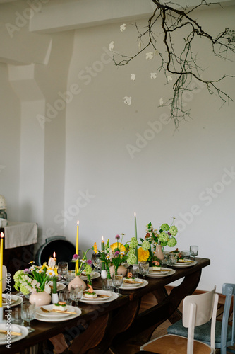 serving the table with fresh flowers and candles