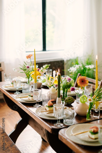serving the table with fresh flowers and candles