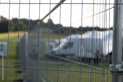 Temporary metal fence installed at Cowdray, July 2023