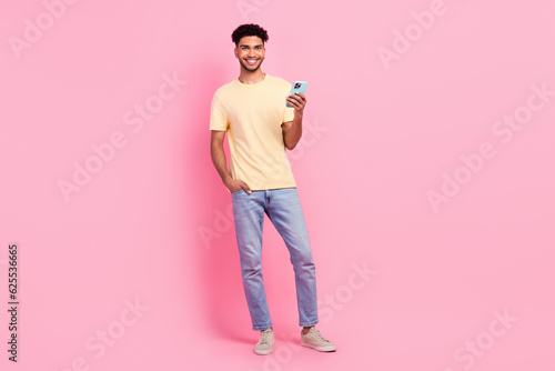 Full length photo cadre of young blogger man hold smartphone wear trendy outfit purchase online clothes isolated on pink color background
