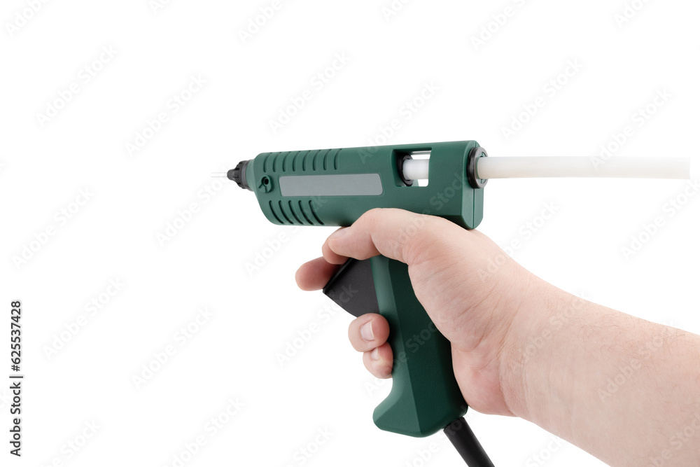 Glue gun on a white background. Electric glue gun close-up on a white background Glue gun on a white background. Electric glue gun close-up on a white background