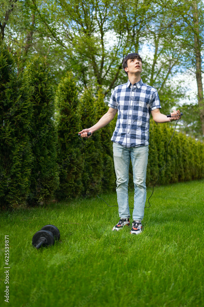Man doing a jumping rope exercise in a public park Man doing a jumping rope exercise in a public park