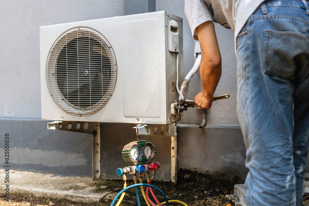 The electrician repairing the air conditioner, Technician is checking the coolness air compressor The electrician repairing the air conditioner, Technician is checking the coolness air compressor