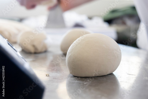 The hands of a Neapolitan pizza chef working the dough