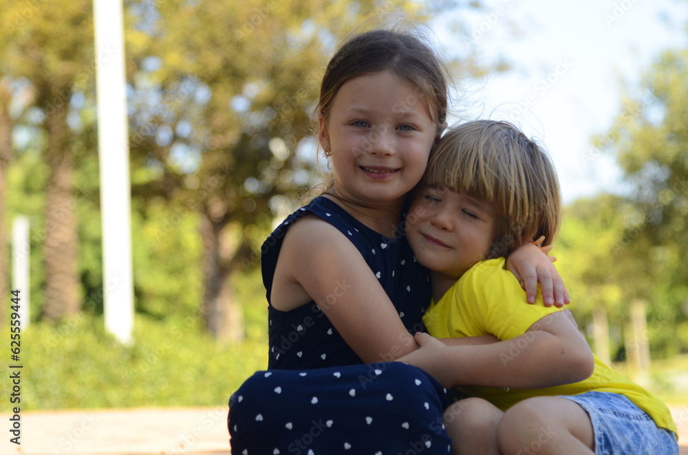 Brother and sister are preschoolers. Lovely children 4-5 years old. The older sister takes care of the younger one. Best friends. Children on a walk. First love, care, hugs Brother and sister are preschoolers. Lovely children 4-5 years old. The older sister takes care of the younger one. Best friends. Children on a walk. First love, care, hugs