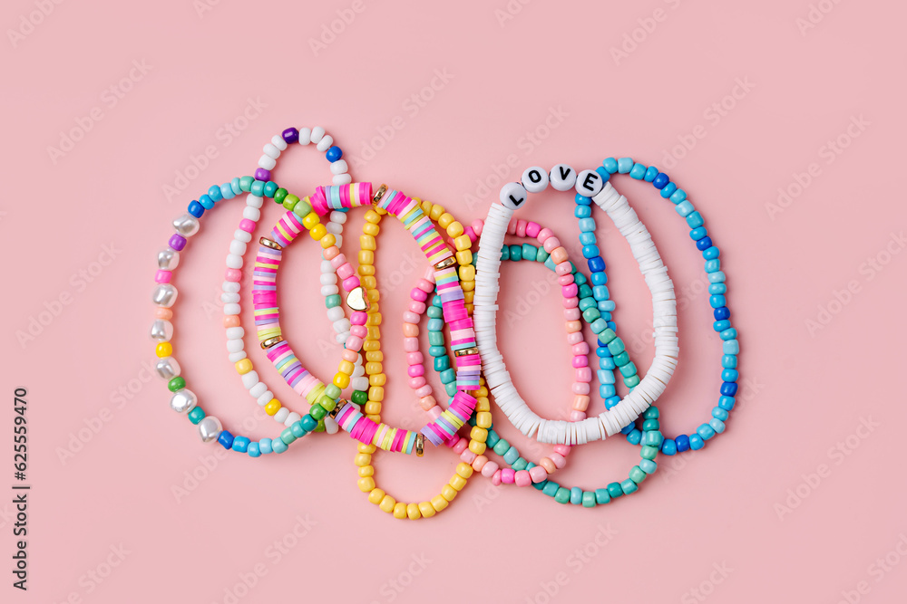 Kids handmade beaded jewelry. Necklaces and bracelets made from multicolored beads and pearls. DIY bracelet beads. Children s needlework. Creativity and hobby. Art activity for kids Stock Adobe Stock
