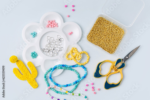 Set of for needlework and beading. Kids handmade beaded jewelry and different multi-colored beads for children's crafts in boxes. DIY art activity for kids. Motor skills, creativity and hobby.