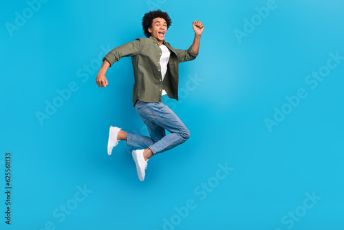 Fotografiet Full body size photo of run young man wear khaki shirt denim jeans hurry go blac