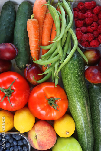 Wooden crate full of healthy colorful seasonal fruit and vegetable. Top view.