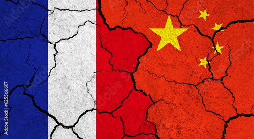 Flags of France and China on cracked surface - politics, relationship concept