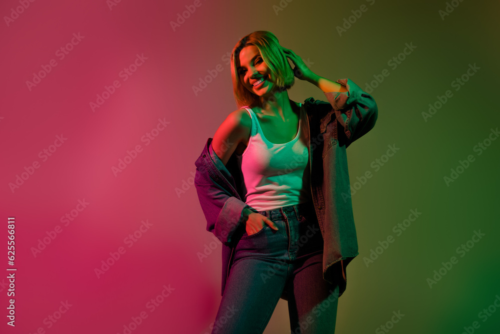 Photo of shiny pretty lady wear denim jacket smiling empty space isolated green pink gradient color background Photo of shiny pretty lady wear denim jacket smiling empty space isolated green pink gradient color background