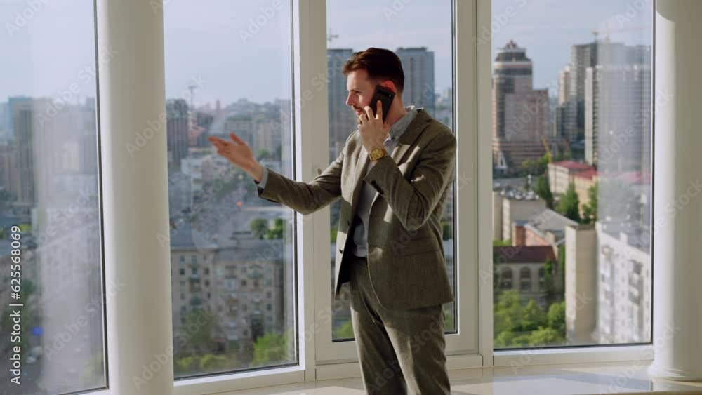 A successful young businessman in a nice suit in the office near the window have an active phone call. He is angry and yell, or scream. The concept of happiness, success, and good emotions A successful young businessman in a nice suit in the office near the window have an active phone call. He is angry and yell, or scream. The concept of happiness, success, and good emotions