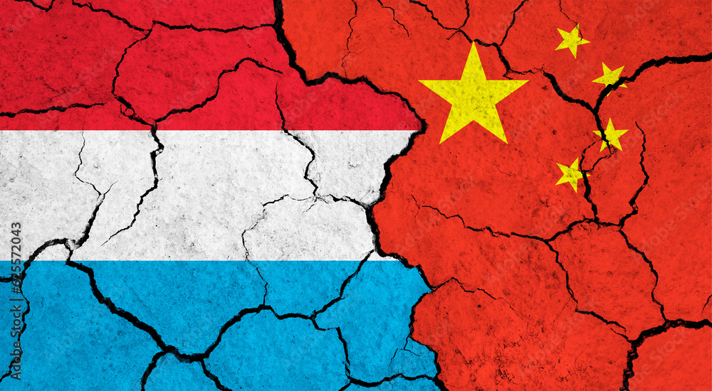 Flags of Luxembourg and China on cracked surface - politics, relationship concept Flags of Luxembourg and China on cracked surface - politics, relationship concept
